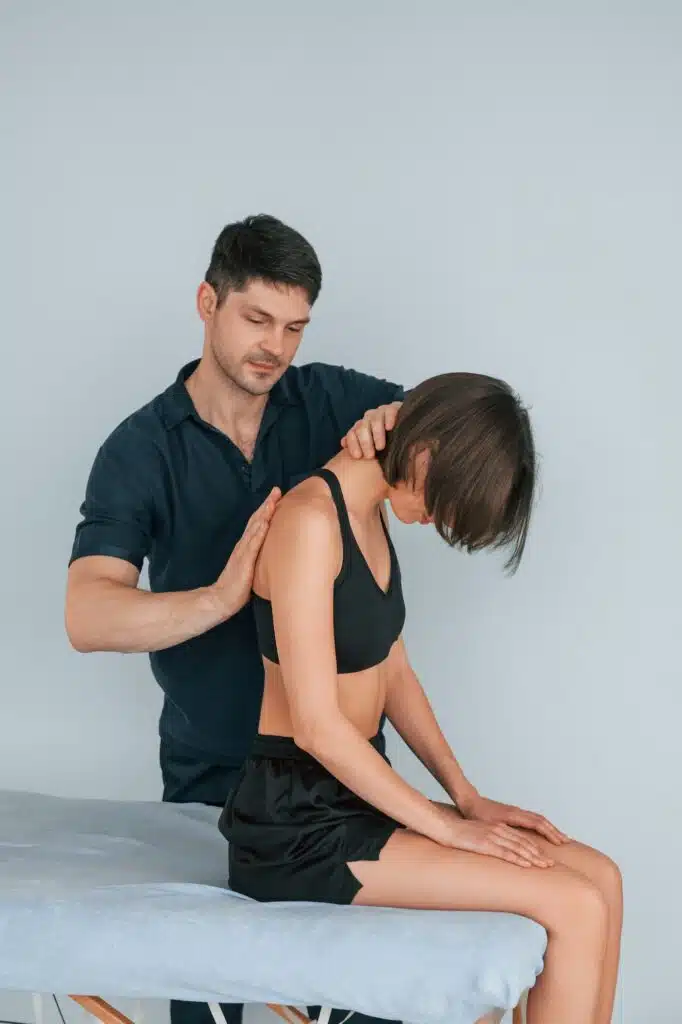 Working with spine and neck. Woman visiting physiologist that making massage